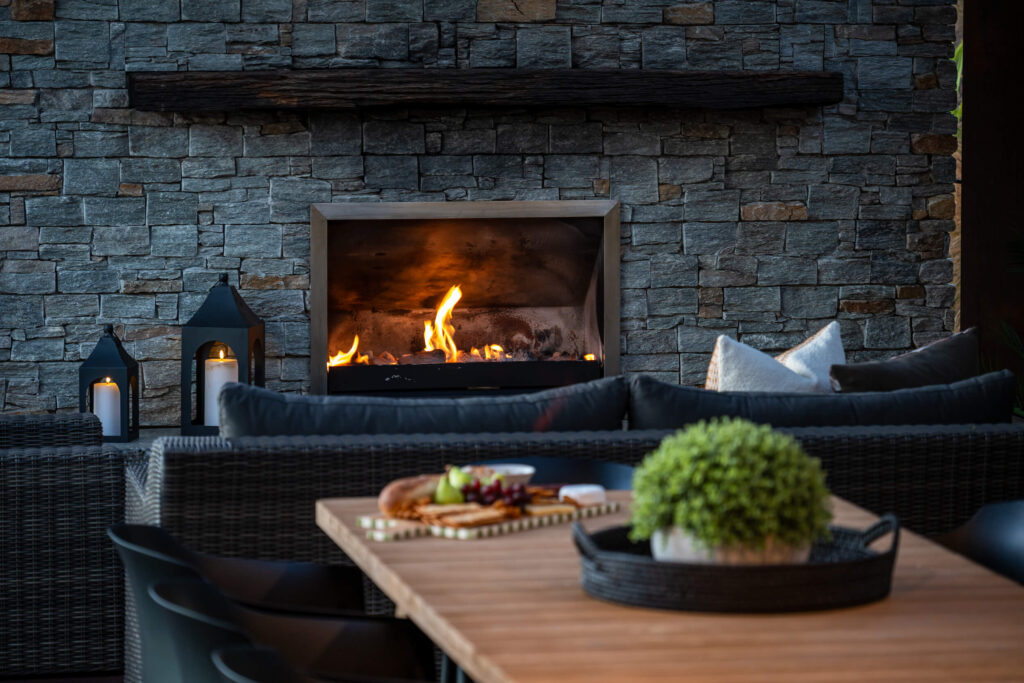 Roaring outdoor fire next to hot tub and outdoor dining